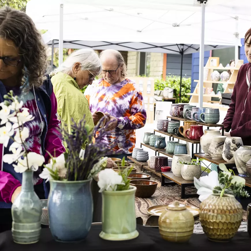 Guests look at pottery during the Greater Austin Clay Studio Tour