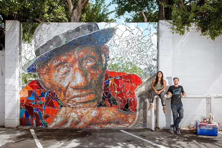 The Mosaic Project's Carmen Rangel and J Muzacz next to the Roosevelt "Grey Ghost" Williams mural